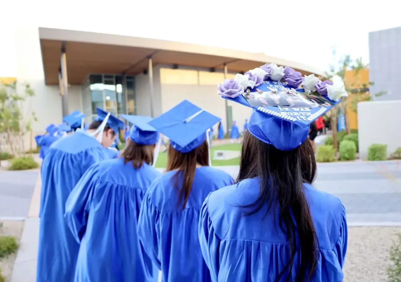 HS Graduates lined up outside, waiting for their ceremony to begin.